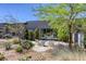 Stylish outdoor patio with stone pavers, seating, and modern landscaping provides a tranquil space for relaxing and entertaining at 787 Keyland St, Las Vegas, NV 89138