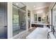 Bright bathroom featuring a soaking tub, walk-in shower, and modern vanity with double sinks at 787 Keyland St, Las Vegas, NV 89138