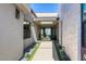 Elegant entryway with sleek design, modern lighting, and curated desert landscaping leading to glass front door at 787 Keyland St, Las Vegas, NV 89138