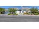 Modern home showcasing sleek design, desert landscaping, stone accents, and a glass garage door at 787 Keyland St, Las Vegas, NV 89138