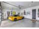 Spacious, modern garage with epoxy floors, wall decor, and room for multiple vehicles offers secure parking and stylish storage at 787 Keyland St, Las Vegas, NV 89138