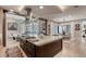 Large kitchen island features a cooktop and the room flows into the dining area with seating and modern decor throughout at 787 Keyland St, Las Vegas, NV 89138
