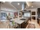 Open concept kitchen with a large center island, stainless steel appliances and view to the dining room and outdoor living space at 787 Keyland St, Las Vegas, NV 89138