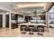 A gourmet kitchen boasts stainless steel appliances, a large central island with seating, and ample cabinet space for storage at 787 Keyland St, Las Vegas, NV 89138
