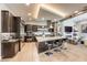 A modern kitchen with stainless steel appliances, a large island with seating, and a view into the living room fireplace at 787 Keyland St, Las Vegas, NV 89138