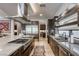 Modern kitchen with stainless steel appliances, a large island with cooktop, and built-in cabinets for a sleek design at 787 Keyland St, Las Vegas, NV 89138