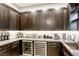 Well-appointed kitchen featuring built-in cabinets and a wine refrigerator, offering ample storage and convenience for entertaining at 787 Keyland St, Las Vegas, NV 89138