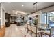 Open-concept living area featuring a modern kitchen, dining space, and fireplace, bathed in natural light at 787 Keyland St, Las Vegas, NV 89138