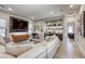 Open-concept living room with modern furniture, a large TV, and stylish built-in shelving at 787 Keyland St, Las Vegas, NV 89138
