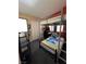 Cozy bedroom featuring a bunk bed with a built-in desk and ample natural light from the window at 837 Holly Lake Way, Henderson, NV 89002