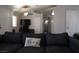 Inviting living room with a plush couch and an open doorway to a bathroom at 837 Holly Lake Way, Henderson, NV 89002