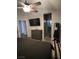 Primary bedroom offers a ceiling fan, mounted TV, dresser, and doorway to an ensuite bathroom at 837 Holly Lake Way, Henderson, NV 89002