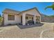 Rear view of the home's facade, showcasing a covered patio and low-maintenance landscaping at 89 Autumn Day St, Henderson, NV 89012