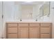 Bright bathroom with a double sink vanity, neutral countertops, and a framed mirror at 89 Autumn Day St, Henderson, NV 89012