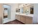 Bathroom boasts double sinks, a large mirror, and neutral fixtures at 89 Autumn Day St, Henderson, NV 89012