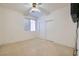Bedroom boasts ceiling fan, sliding closet doors and window at 89 Autumn Day St, Henderson, NV 89012