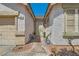 View of the front entrance featuring security system, front door, window, and walkway at 89 Autumn Day St, Henderson, NV 89012