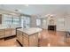 Kitchen with stainless appliances, many cabinets, and a central island flows into the living room at 89 Autumn Day St, Henderson, NV 89012