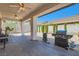 Spacious covered patio with ceiling fans and a barbecue grill, perfect for outdoor entertaining at 89 Autumn Day St, Henderson, NV 89012