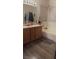 Bright bathroom featuring a double vanity, a large mirror, a soaking tub, and a window for natural light at 8913 Cambridge Glen Ct, Las Vegas, NV 89149