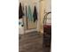 Well-lit bathroom showcasing wood-look floors, a shower with glass doors, and a convenient storage rack at 8913 Cambridge Glen Ct, Las Vegas, NV 89149