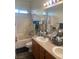 Well-lit bathroom with double sink vanity and a shower-tub combo at 8913 Cambridge Glen Ct, Las Vegas, NV 89149