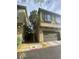 View of attached two car garage and facade for the town house at 8913 Cambridge Glen Ct, Las Vegas, NV 89149