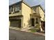 Two story townhouse with attached two car garage and tiled roof detail at 8913 Cambridge Glen Ct, Las Vegas, NV 89149