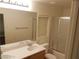 Bathroom with double sinks, mirror, and a shower with glass doors at 8982 Leaping Pad Ct, Las Vegas, NV 89148