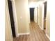 A well lit hallway with wood-look flooring leading to other rooms at 8982 Leaping Pad Ct, Las Vegas, NV 89148
