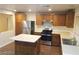Bright kitchen featuring a center island, stainless appliances, and ample cabinet space at 8982 Leaping Pad Ct, Las Vegas, NV 89148