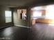 Open living room with an attached kitchen and hardwood floors at 8982 Leaping Pad Ct, Las Vegas, NV 89148