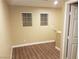 This room features wood-look flooring and has two windows with blinds at 8982 Leaping Pad Ct, Las Vegas, NV 89148