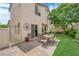 The backyard features an outdoor dining area, grass, and lush landscaping at 9082 Amanda Creek Ct, Las Vegas, NV 89149