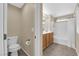 Well-lit bathroom featuring a toilet, sink, vanity, and shower over tub at 9082 Amanda Creek Ct, Las Vegas, NV 89149