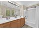 Bright bathroom with double vanity, large mirror, and shower over tub combo at 9082 Amanda Creek Ct, Las Vegas, NV 89149