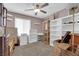 Bright bedroom with ceiling fan, organized shelves, and storage at 9082 Amanda Creek Ct, Las Vegas, NV 89149