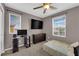 Bedroom featuring a ceiling fan, two windows, and carpeted floors at 9082 Amanda Creek Ct, Las Vegas, NV 89149