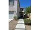 Welcoming home featuring a covered front entry, concrete walkway, complemented by neat landscaping and a two-car garage at 9082 Amanda Creek Ct, Las Vegas, NV 89149