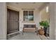 Inviting front porch with a cozy bench and decorative potted plant at 9082 Amanda Creek Ct, Las Vegas, NV 89149