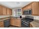 View of kitchen features, including wooden cabinets and stainless steel appliances at 9082 Amanda Creek Ct, Las Vegas, NV 89149