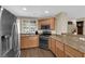 Bright kitchen featuring wooden cabinets, granite countertops, and a stainless steel refrigerator at 9082 Amanda Creek Ct, Las Vegas, NV 89149