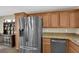 Kitchen featuring stainless steel appliances, wooden cabinets, and granite counters at 9082 Amanda Creek Ct, Las Vegas, NV 89149