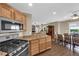 Kitchen flows into dining area, with wooden floors, granite counters, and open layout at 9082 Amanda Creek Ct, Las Vegas, NV 89149