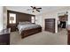 Primary bedroom featuring dark wood furniture, carpet, and large window at 9082 Amanda Creek Ct, Las Vegas, NV 89149