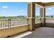 Exterior view of a balcony with concrete floor, stucco columns and a railing with an outdoor golf course view at 9125 Las Manaitas Ave # 302, Las Vegas, NV 89144