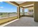 Wide angle exterior view showing a concrete open air balcony overlooking the golf course with railing and stucco columns at 9125 Las Manaitas Ave # 302, Las Vegas, NV 89144