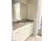 Modern bathroom vanity with white cabinets, countertop, and mirror at 9125 Las Manaitas Ave # 302, Las Vegas, NV 89144