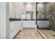Bright bathroom with dual vanities, modern fixtures, and a glass-enclosed shower with elegant tile accents at 9125 Las Manaitas Ave # 302, Las Vegas, NV 89144