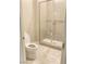 Bathroom featuring tiled shower with a glass door, and a white toilet at 9125 Las Manaitas Ave # 302, Las Vegas, NV 89144
